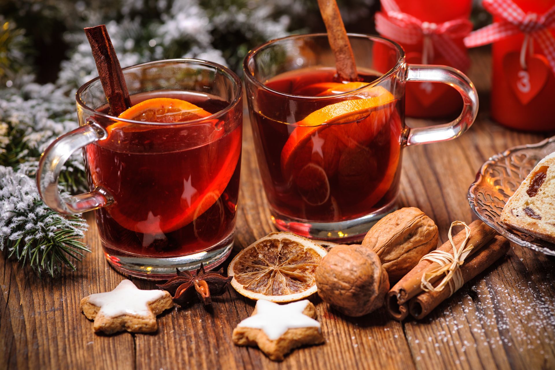 Christmas mulled wine on table with burning advent candles and christmas decorations