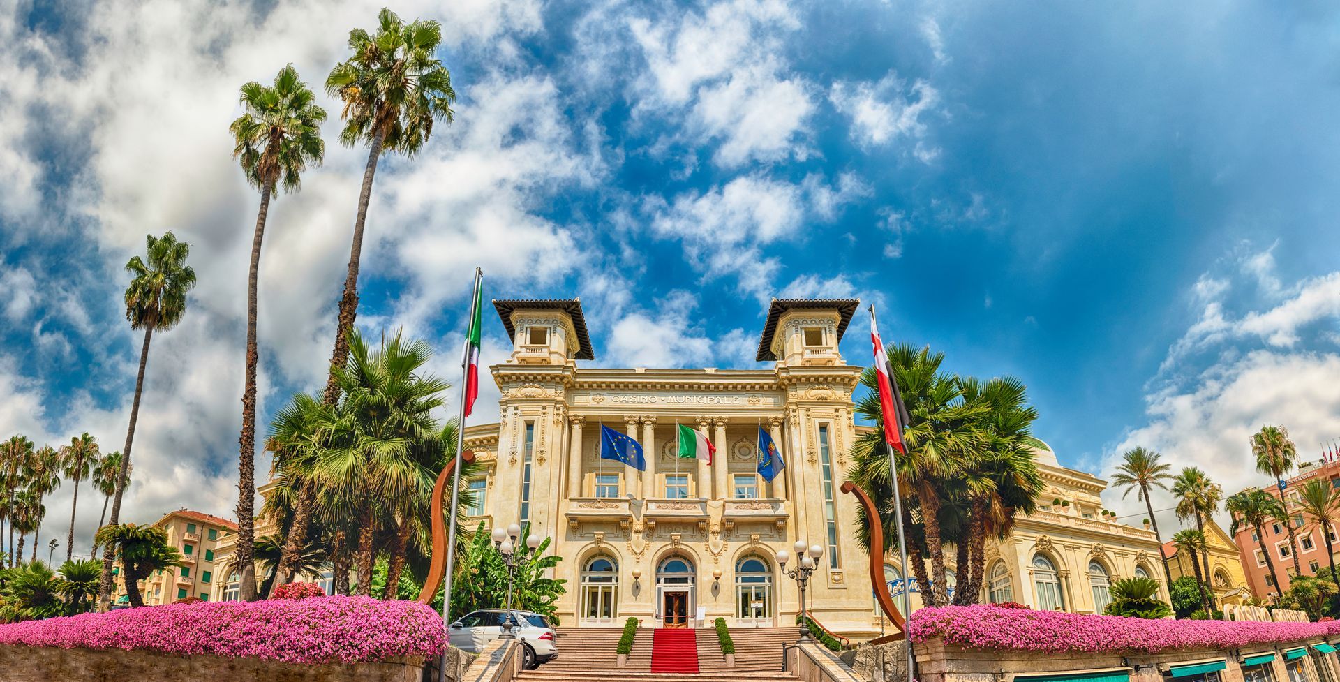 Facade of the scenic Sanremo Casino with palms and flowers
