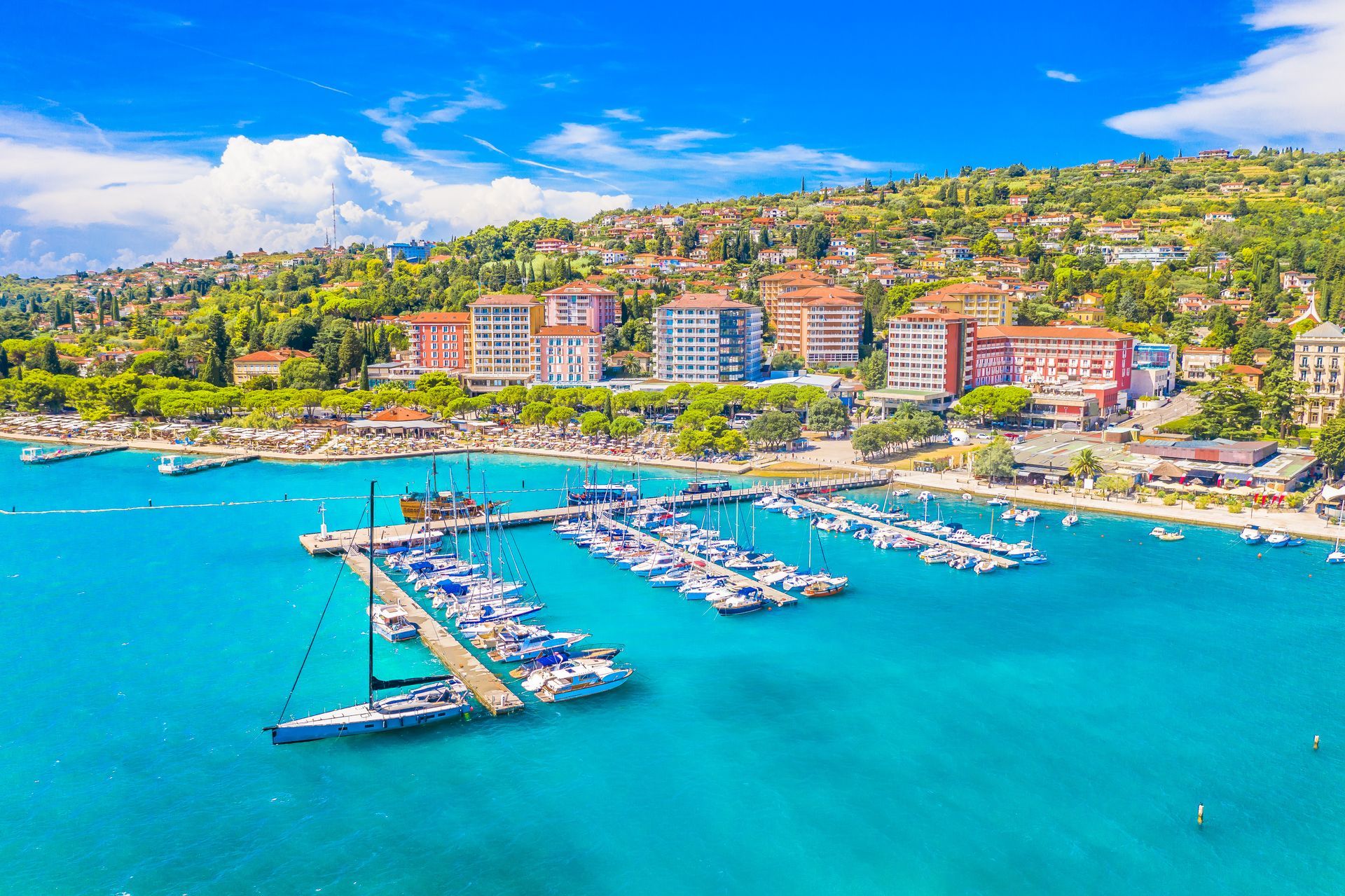 Aerial view of Portoroz, Slovenia, a popular seaside resort town on the Adriatic coast, known for its vibrant waterfront, luxury hotels, marinas, and Mediterranean charm