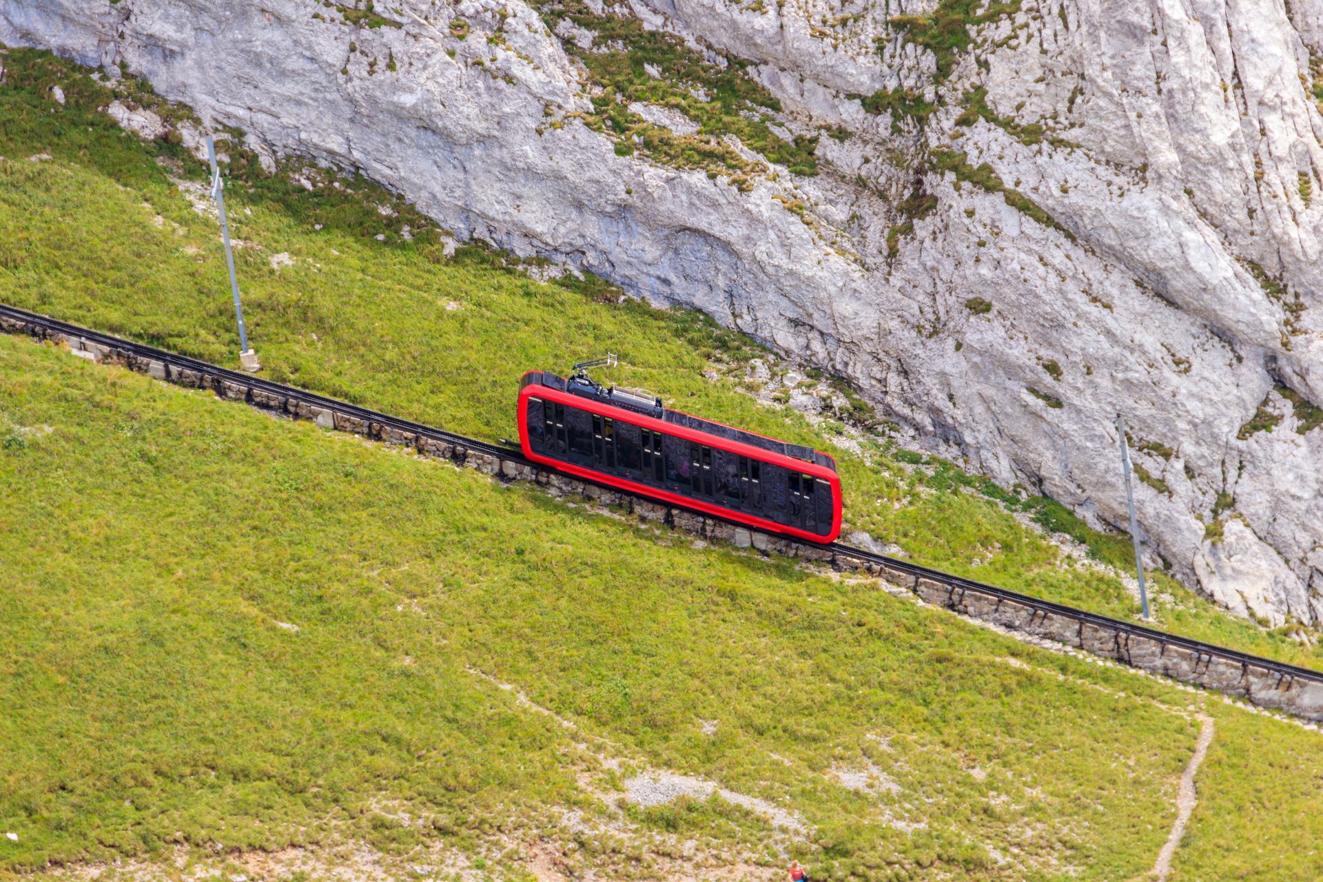 Cogwheel train climbing to the top of Mount Pilatus in Canton Lucerne, Switzerland. World's steepest cogwheel railway