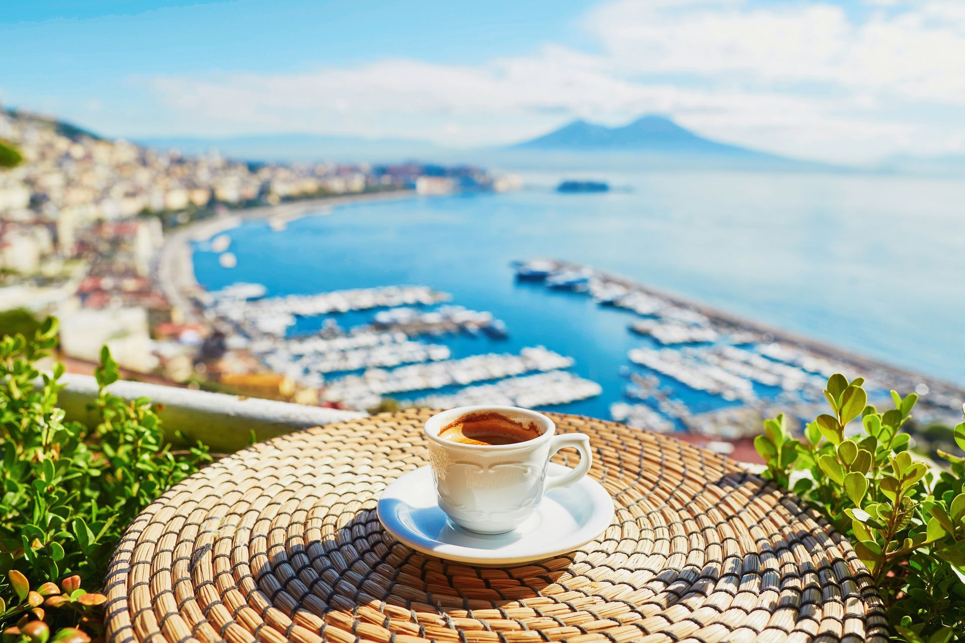 Cup of fresh espresso coffee in a cafe with view on Vesuvius mount in Naples, Campania, Southern Italy